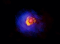 アルマ望遠鏡が撮影した、巨大原始星「G353.273+0.641」。原始星周囲のコンパクトな構造を赤、円盤を黄、その外側に広がるガス（エンベロープ）は青として疑似カラー合成されている。(c) ALMA (ESO/NAOJ/NRAO), Motogi et al.