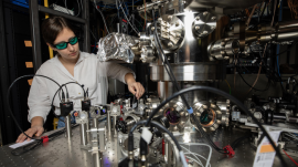 GTRI Research Scientist Darian Hartsell makes adjustments to an improved cryogenic vacuum chamber that helps reduce some common noise sources by isolating ions from vibrations and shielding them from magnetic field fluctuations. (Gtri.gatech.edu)